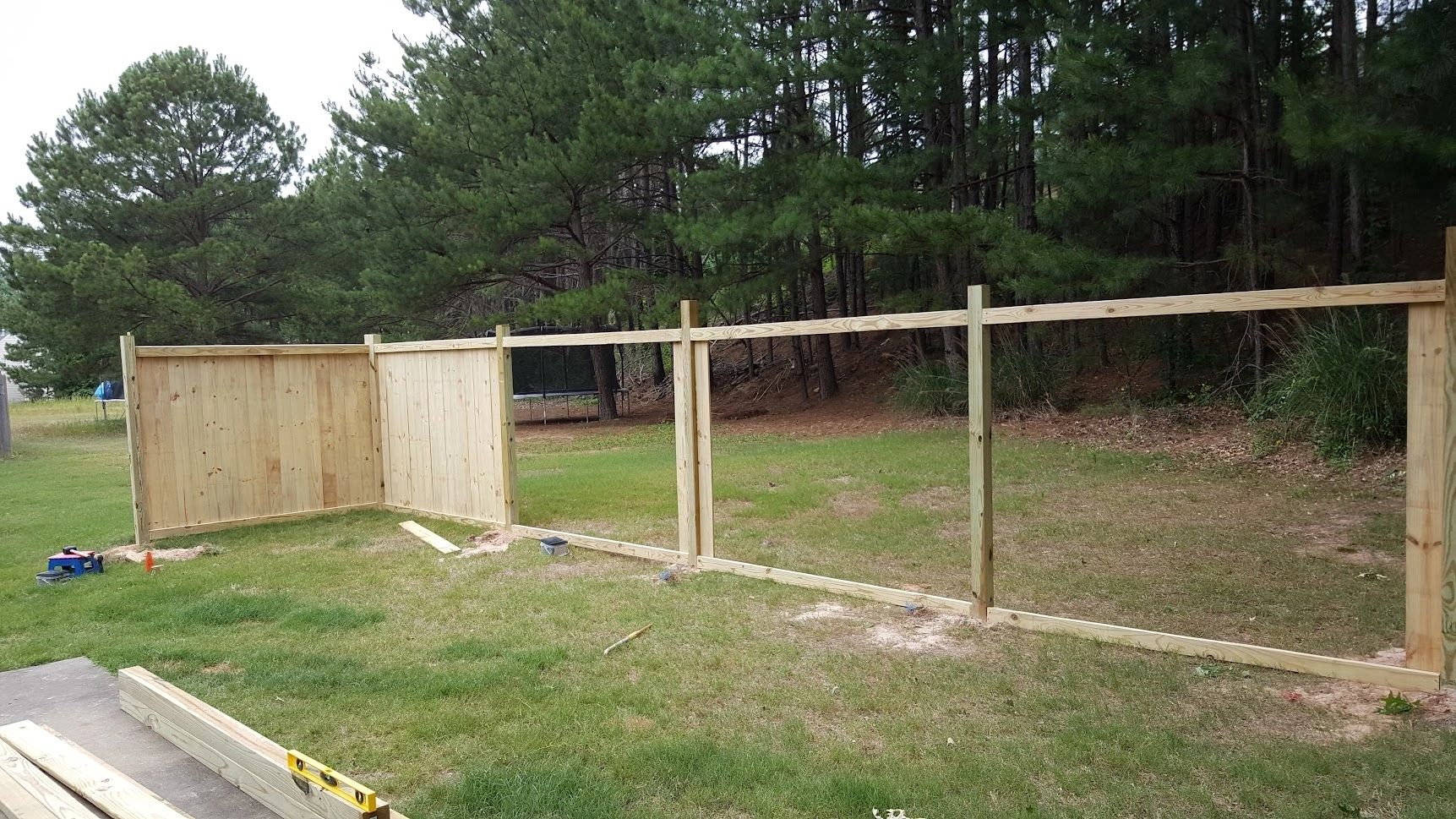 Fence construction backyard grassy yard